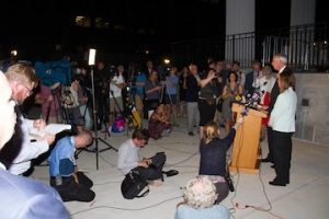 Reporters circles around podium after verdict
